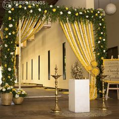 a wedding stage decorated with yellow and white flowers