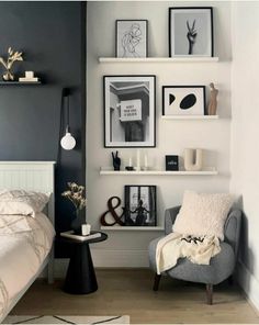 a bedroom with gray walls and pictures on the wall