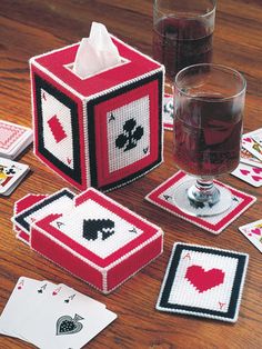 a table topped with cards and cups filled with liquid