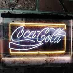 a neon sign hanging from the side of a brick wall