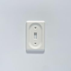 a white light switch cover on a wall