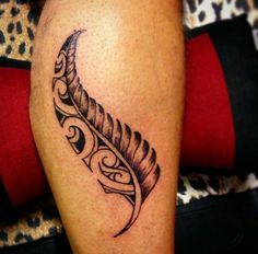 a woman's leg with a tattoo design on it and a feather in the middle