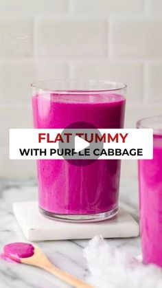 a pink substance in a glass next to a spoon and cup with the words flat tummy on it