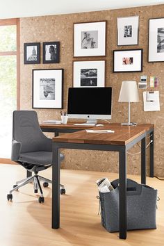 an office with a desk, chair and pictures on the wall above it is shown