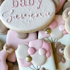 baby shower cookies with teddy bears and pink icing on them, all decorated in pastel colors