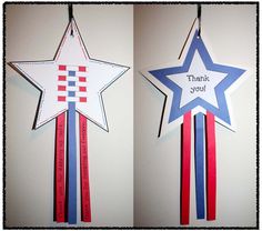 two patriotic stars hanging on the wall, one with a ribbon that says thank you