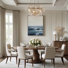 an elegant dining room with chandelier and white flowers in vases on the table