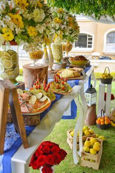 a table filled with lots of food and flowers