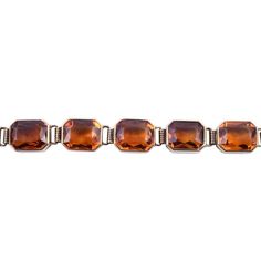 This is part of Chairish’s Fine Jewelry assortment.  Vintage bezel set citrine bracelet, circa 1950-60. This 14 karat yellow gold bracelet features 13 bezel set cut cornered citrine, each measuring approximately 10mm x 8mm. This citrine bracelet is 7.5″ long.   Metal: 14k Gold,Yellow Gold Stone: Citrine Stone Cut: Square Cut Luxury Citrine Jewelry With Bezel Setting, Classic Citrine Rectangular Jewelry, Formal Citrine Bracelet, Luxury Bezel-set Bracelet, Yellow Rectangular Citrine Jewelry, Citrine Bracelet, Square Cut, Citrine Stone, Yellow Gold Bracelet