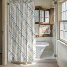 a bath room with a tub and a shower curtain