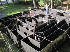 a man standing in the middle of a large building made out of cinder blocks and wire