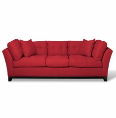 a red couch sitting on top of a white floor