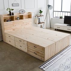 a bedroom with a bed, dresser and television