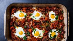 an overhead view of a casserole dish with eggs on top and noodles in the bottom