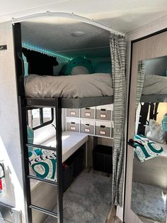 a bunk bed in the corner of a room with mirrored walls and drawers on both sides