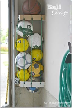 a rack with soccer balls and other sports equipment