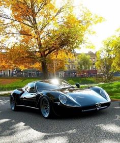 a black sports car is parked on the street