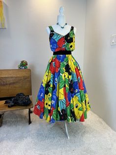 1980s dress / 80s dress / vintage 1980s dress / 1980s does 1950s dress / 1980s dress / vintage 1950s style dress / vintage sundress This 1980s sundress is amazing. First let me start by saying this is one of those simple dresses that has so much style. She is a sundress with a button front and a comfortable elastic waist band. But what I really love is her vibrant print and the full skirt with hidden pockets! Classic sundress cut, but with a gorgeous bold colors means you will never see anyone else in this dress! Truly a timeless dress made for fun!  Measurements provided are flat and have been doubled. Bust 36"  Waist 26-28" range (small) Hips free Length  48" ❤️ Condition: Excellent vintage condition. Flaw: none found. Belt in photos not included. This item has been cleaned and is ready Retro A-line Summer Dress, Summer Retro A-line Vintage Dress, Summer Vintage A-line Sundress, Retro Midi Dress For Garden Party, Summer Party Cotton Vintage Dress, Summer Party Vintage Cotton Dress, Retro Summer Party Dress, Retro Floral Midi Dress For Party, Summer Vintage Fashion A-line Midi Dress