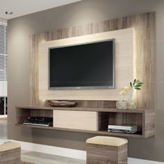 an entertainment center with a flat screen tv mounted on the wall