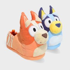 two slippers with cartoon characters on them, one is orange and the other is blue