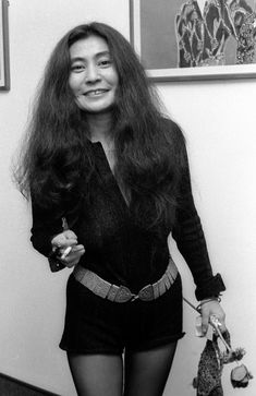 a woman with long hair is posing for the camera