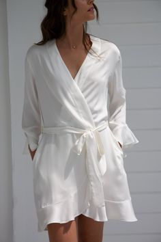 Comfy-chic and eco-luxe, our Ruffle Robe feels like a hug. Silky-soft and sustainably sourced, this women’s robe features ruffle hems with scooped side detail at the sleeves. This women's robe includes a removable tie that sits at the high waist. Our Cloud color robe is the perfect gift for a bride-to-be to wear as she gets ready for her wedding day and beyond. Sunrise (pale peach), Cloud (white), Lilac, and Dusty Lavender Inside tie Removable outside tie Pockets Naturally dyed with plants 100% Comfy Chic, Women's Robe, Ruffle Romper, Ruffle Shorts, Naturally Dyed, Ruffle Hem, Short Sets, Wrap Dress, Lilac