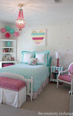 a bedroom decorated in pink, aqua and white