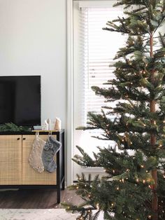 a christmas tree in front of a flat screen tv