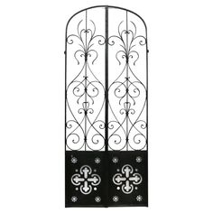 an iron gate with decorative designs on the sides and bottom panels, isolated against a white background