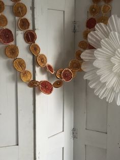 some orange slices are hanging on a white door