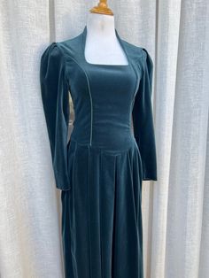 "Vintage Laura Ashley Romantic Victorian Style turquoise/teal Velvet long dress with long sleeves and side zipper closure. Corset style top. The dress is in a great condition, minor tear on left armpit, easily fixable by skilled seamstress. Marked size 6, see measurements below for proper fit.   Measurements (flat): Shoulder to shoulder: 15\" Sleeve length: 22\" Armpit to armpit: 16\" Waist: 28\" Skirt length: 31\" Overall length: 51\"" Green Fitted A-line Long Sleeve Dress, Fitted A-line Long Sleeve Winter Dress, Fitted Long Sleeve A-line Dress For Winter, Green Long Sleeve Dress With Fitted Bodice, Long Sleeve Dress With Fitted Bodice, Fitted Green Dress With Back Zipper, Formal Long Sleeve Dress With Back Zipper, Fitted A-line Long Sleeve Dress For Fall, Fitted Dress With Back Zipper For Fall