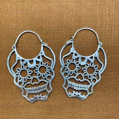 Day of the Dead Sugar Skull Hoop EarringsThese are so fun to wear, lightweight and sturdy.-Plain Brass with 20 gauge half-hard Brass Wire OR-Solid 925 Sterling Silver with 20 gauge half-hard Sterling Silver wire 1 5/8" width and 2 1/8" hanging length. Sugar Skull Earrings, Metal Clay Jewelry, Skull Earrings, Halloween Jewelry, Metal Clay, May 1, Day Of The Dead, Silver Wire, Clay Jewelry