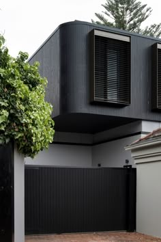 a black and white house with shutters on the windows