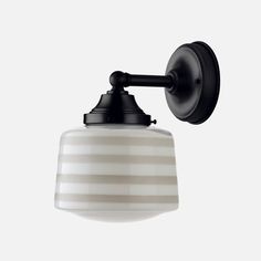 a black and white striped light fixture on a wall with an attached arm that is mounted to the side of it