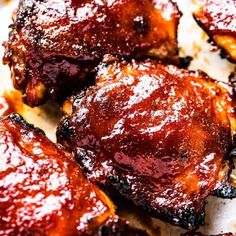 closeup of barbecue chicken wings with bbq sauce on them, ready to be eaten