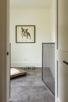 an open door leading to a room with a painting on the wall and dog bed