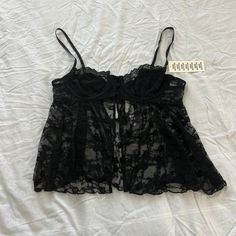 Urban Outfitters Sheer Lace Cropped Babydoll Cami Size Large Condition: Nwt Color: Black Details : - Babydoll Cami With A Delicate + Femme Lace With A Sheer Finish. - Cropped Above The Waist With Opaque Demi Cups - A Mini Button Placket At The Front And A Flowy Bodice With A Split Hem. - Topped With Scalloped Trim At The Bust And A Keyhole Cutout At The Back. - Adjustable Spaghetti Straps + Hook & Eye Placket At The Back Extra: - I Ship Between 1-2 Days Babydoll Cami, Demi Cup, Scalloped Trim, Babydoll Top, Urban Outfitters Tops, Hook Eye, Split Hem, Lace Tops, Sheer Lace