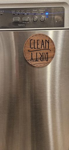 a stainless steel dishwasher with a wooden sign on the door that says clean