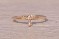 This stunning piece, known as The Celestial Cross, features a captivating diamond cross design set in 14 karat yellow gold. The ring is crafted in 14 karat yellow gold and is currently a finger size 6.75 yet can be adjusted to any finger size for an additional charge upon request, ensuring a perfect fit. Love this piece, but don't have the money to spend right now? We offer FREE layaway on every item in our shop. With just 20% down, take one full year (interest-free) to pay off your new jewelry! Cross Ring, Diamond Cross, Cross Design, New Jewelry, Cross Designs, Design Set, Rings Statement, Statement Rings, Jewelry Box