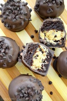 chocolate covered desserts are sitting on a wooden cutting board and ready to be eaten