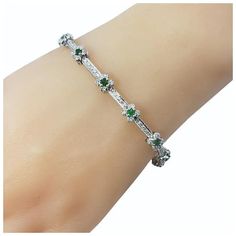 This stunning bracelet features 13 round emeralds (2 mm each) and 112 round brilliant cut diamonds set in classic 18K white gold.    Width:  5 mm  Total diamond weight:  1.10 ct.  Diamond color: H-J  Diamond clarity: SI1  Size: 6.75 inches  Weight:  7.9 dwt. /  12.4 gr.  Stamped: 18K  BA  Very good condition, professionally polished.  Will come packaged in a gift box or pouch (when possible) and will be shipped U.S. Priority Mail Insured. Luxury Silver Tennis Bracelet With Emeralds, Elegant Silver Tennis Bracelet With Emeralds, Silver Emerald Tennis Bracelet For Formal Occasions, Formal Silver Tennis Bracelet With Emeralds, Elegant Silver Emerald Tennis Bracelet, Formal Silver Emerald Tennis Bracelet, Emerald Diamond Bracelet In White Gold For Formal Events, Green Diamond Bracelet With Brilliant Cut, Green Diamond Bracelets With Brilliant Cut