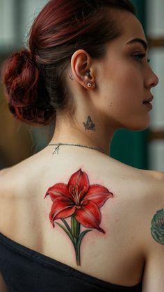 a woman with a red flower tattoo on her back