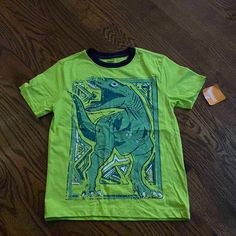 Gymboree Short Sleeve Shirt Nwt Size Medium So Cute With The Dinosaur A Little Boy Will Love This Green Cotton Dinosaur Print Tops, Green Cotton Tops With Dinosaur Print, Green Dinosaur Print T-shirt For Summer, Green Dinosaur Print Summer T-shirt, Dinosaur Print Short Sleeve Tops For Spring, Short Sleeve Dinosaur Print Tops For Spring, Short Sleeve Tops With Dinosaur Print For Spring, Spring Short Sleeve Tops With Dinosaur Print, Green Dinosaur Print Top For Spring