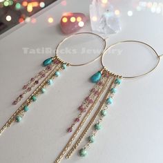 Gorgeous and versatile fringe hoop earrings with genuine Sleeping Beauty/ Arizona Turquoise and watermelon Tourmaline accents.  Perfect for day and night. Available in 14k gold filled, rose gold filled, and all sterling silver. 100% Waterproof Hoops measure 50mm. Turquoise stones are beautiful AAA quality stones. Bohemian Turquoise Earrings With Gemstone Accents, Bohemian Hoop Earrings With Dangling Charms For Gift, Bohemian Hoop Earrings With Dangling Charms As Gift, Bohemian Hoop Earrings With Dangling Charms, Bohemian Dangle Hoop Earrings With Natural Stones, Handmade Fusion Dangle Hoop Earrings, Bohemian Teardrop Earrings With Gemstone Accents, Bohemian Pink Jewelry With Gemstone Accents, Coachella Earrings