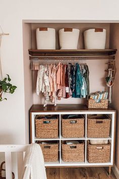 a baby's closet with baskets and clothes