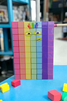 colorful blocks with faces on them sitting on a table