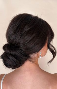 a woman with her hair in a low bun