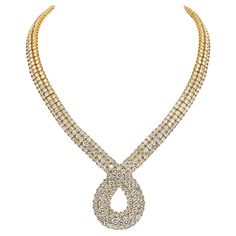 Indulge in the captivating allure of this exquisite diamond scrolling necklace, a vision of timeless elegance. Crafted in 18K Yellow Gold with meticulous detail, the front of the necklace is adorned with three lines of brilliant-cut diamonds, creating a scintillating display of radiance. The diamonds, totaling an impressive 48.00 carats, form a seamless symphony of sparkle that gracefully drapes around the neck. With a length of 16.5 inches, this necklace is designed to accentuate the neckline with a refined and luxurious touch. The scrolling motif adds a sense of fluidity and movement, enhancing the overall beauty of the piece. With an internal circumference of 15 inches, this necklace is not only a striking accessory but also a testament to the craftsmanship and sophistication that defin Luxury Diamond Cut Station Necklace In Yellow Gold, Elegant Luxury Diamond Necklace With Gold Chain, Luxury Yellow Gold Diamond-cut Station Necklace, Luxury Yellow Gold Diamond Necklace With Round Cut, Luxury Yellow Gold Diamond Necklace For Party, Luxury Yellow Gold Long Necklace, Luxury Yellow Gold Chain Necklace With Diamond Cut, Luxury Yellow Gold Necklace With Baguette Diamonds, Luxury Yellow Single Strand Jewelry