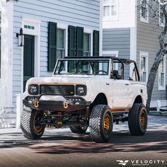 an off - road vehicle parked in front of a house