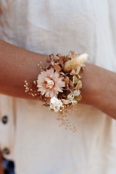 a close up of a person wearing a bracelet with flowers on it's arm